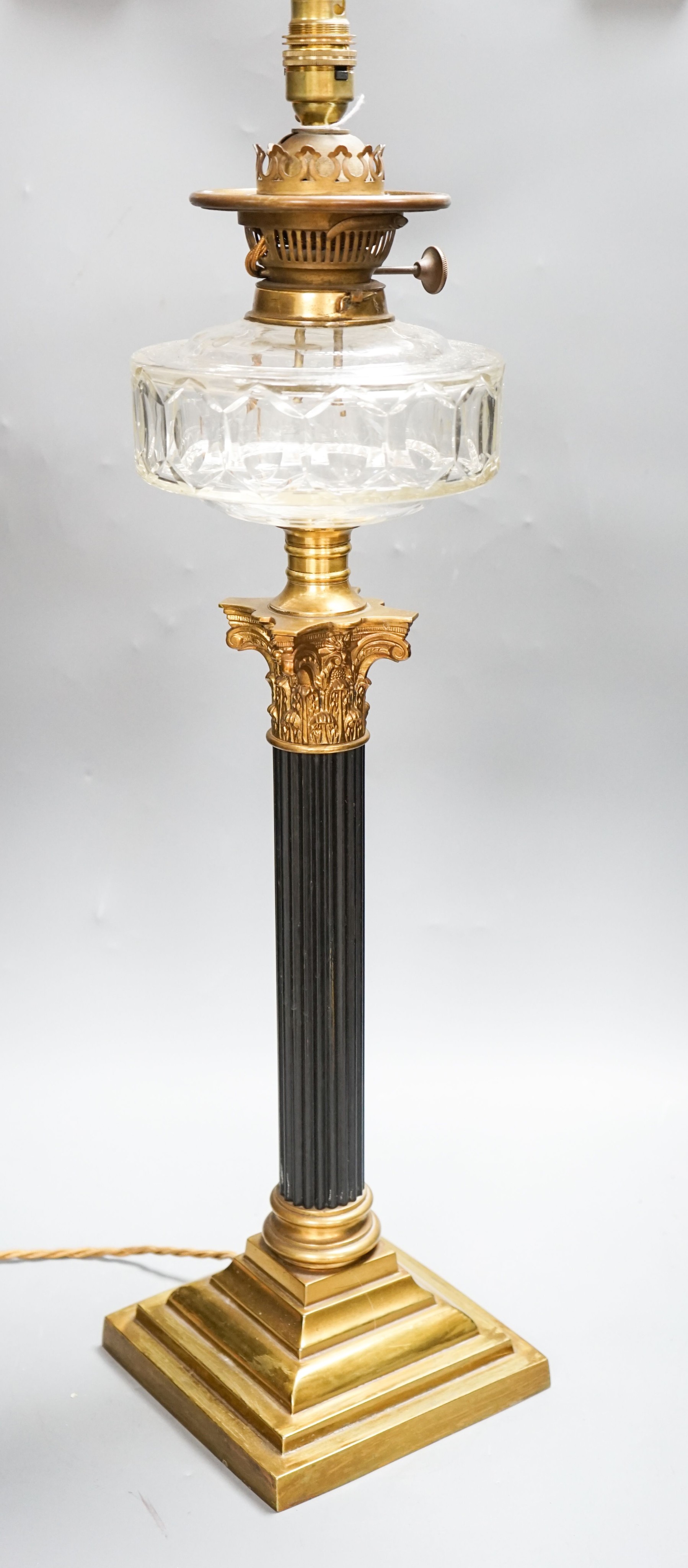 An early 20th century corinthian column oil lamp, converted for electricity, total height 67 cm